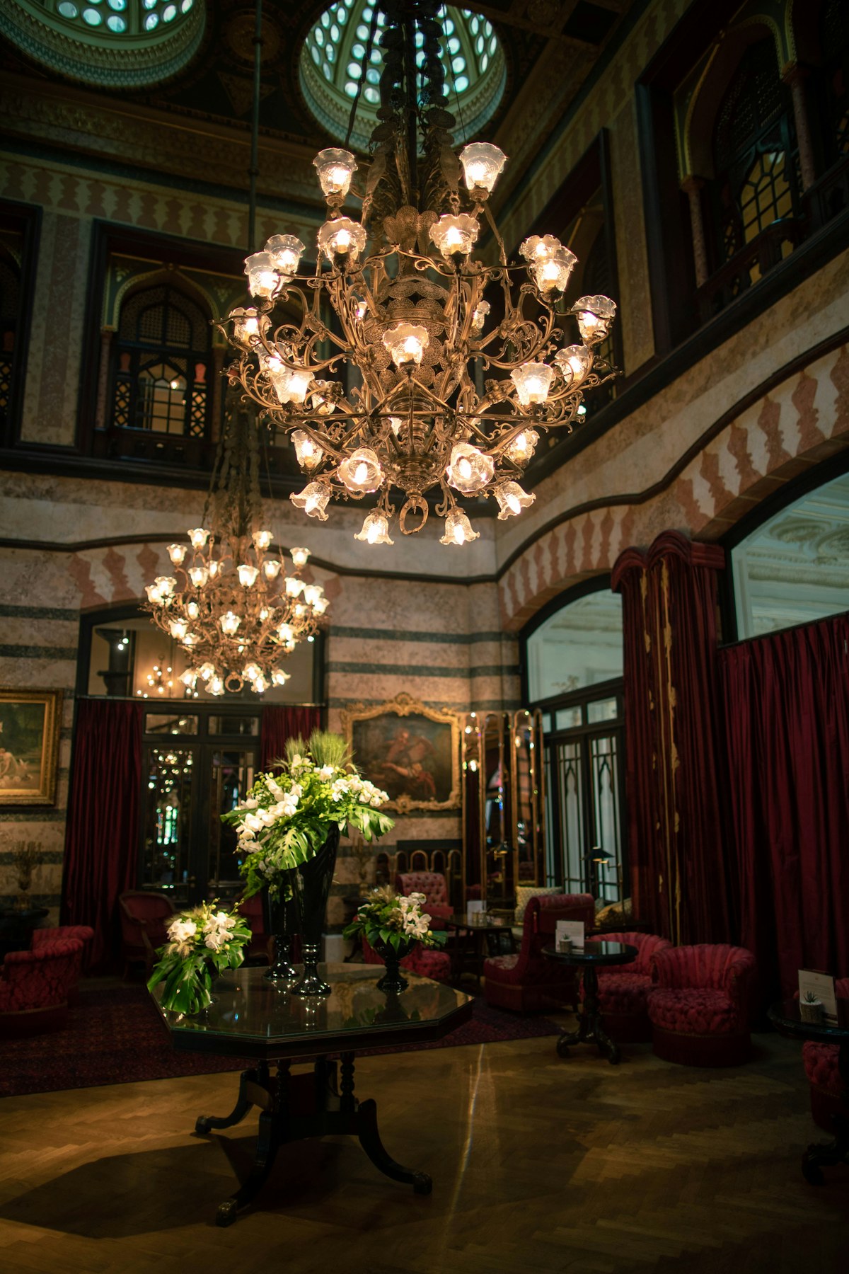 Ornate illuminated chandelier in a grand interior