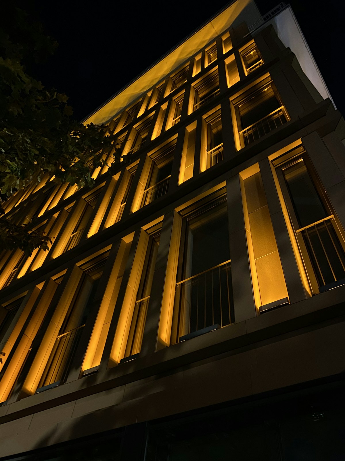 Architectural exterior illuminated warmly at night