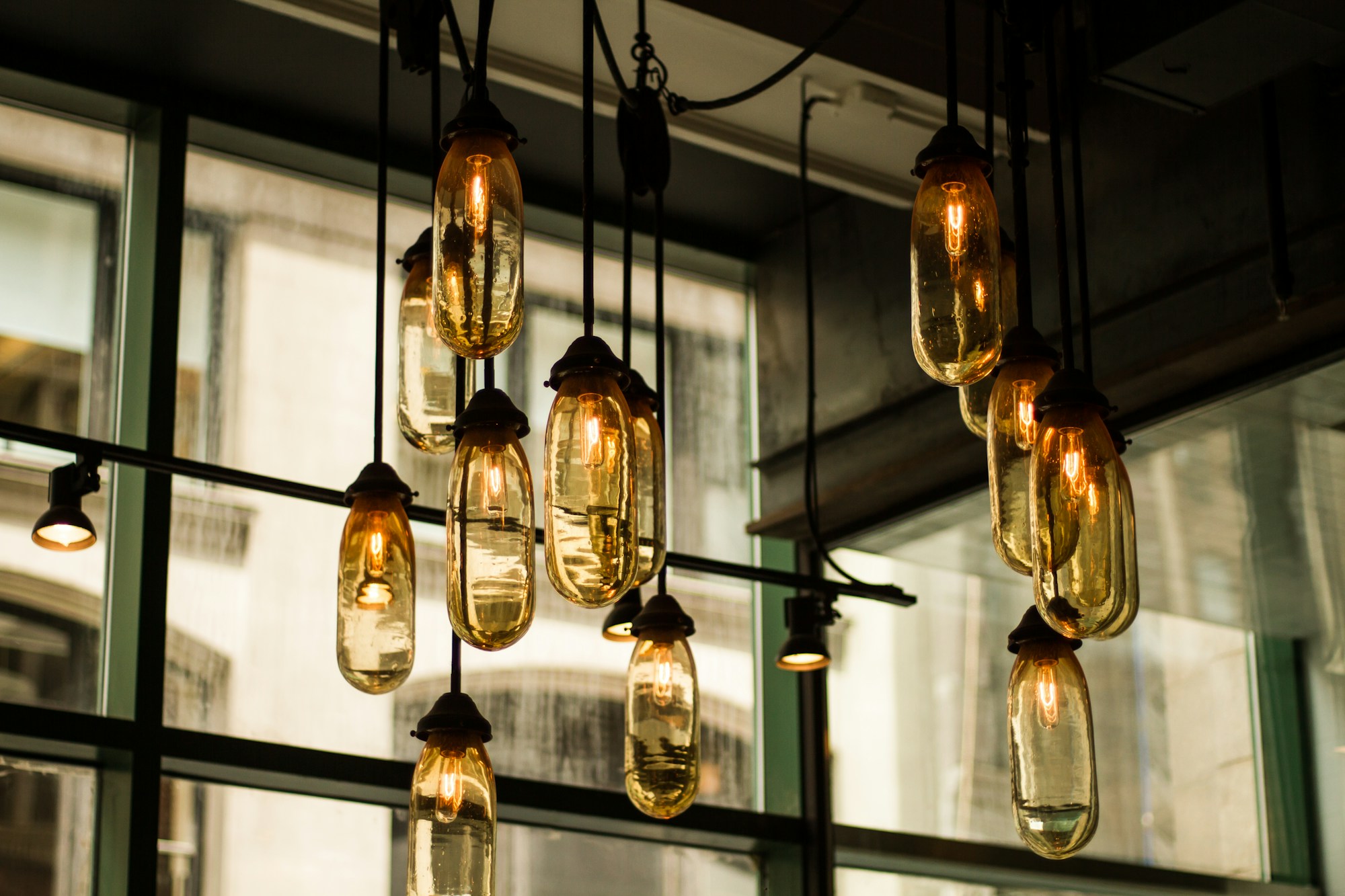 Amber glass pendant lights glowing in a modern interior