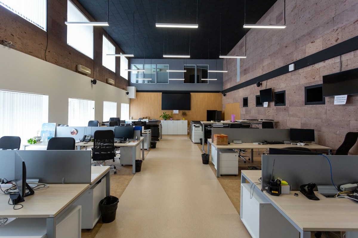 Modern office illuminated with suspended linear LED fixtures